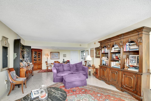 tiled living room featuring a textured ceiling