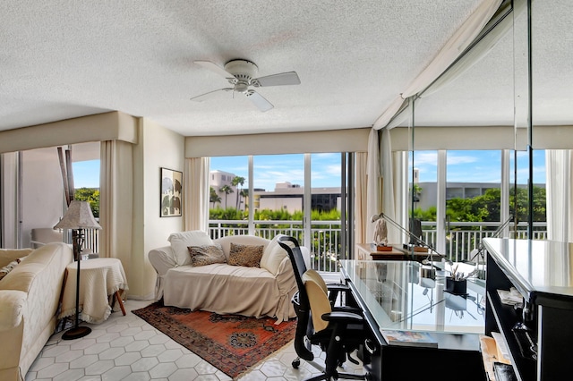 living room with a textured ceiling, tile patterned flooring, and ceiling fan