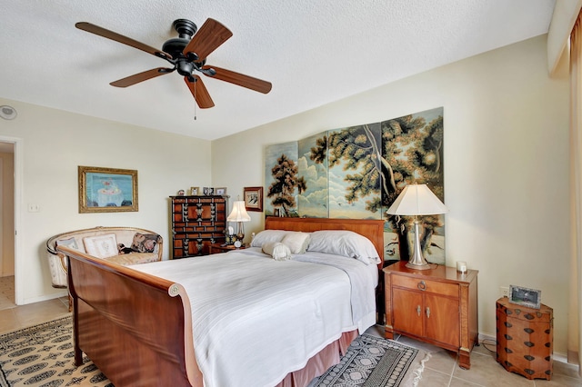 tiled bedroom with a textured ceiling and ceiling fan