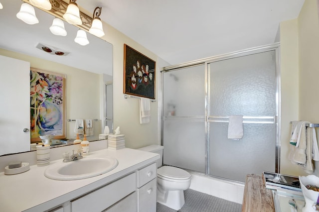 bathroom featuring vanity, toilet, tile patterned flooring, and an enclosed shower