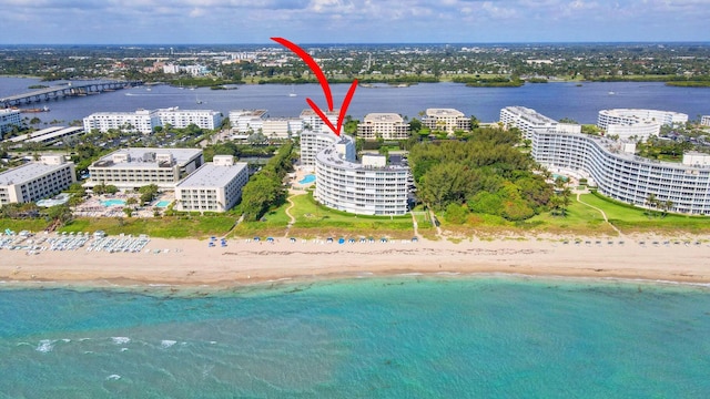 bird's eye view featuring a view of the beach and a water view