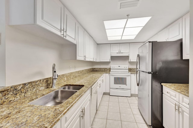 kitchen featuring light tile patterned flooring, white appliances, white cabinetry, and sink