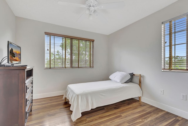 bedroom featuring ceiling fan and dark wood-type flooring