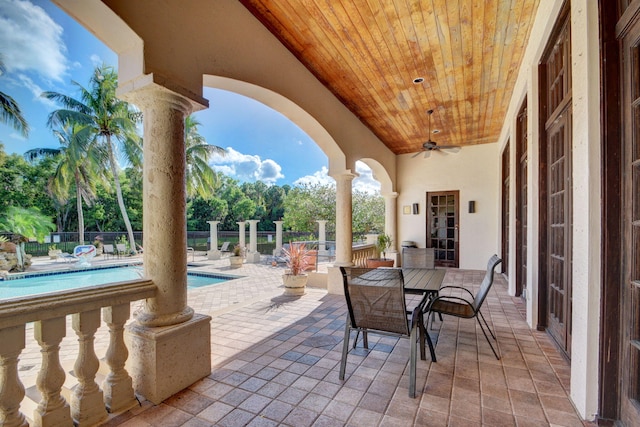 view of patio / terrace featuring a fenced in pool and ceiling fan