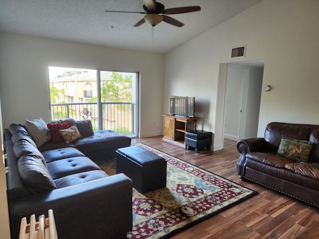 living room with wood-type flooring, a textured ceiling, vaulted ceiling, and ceiling fan