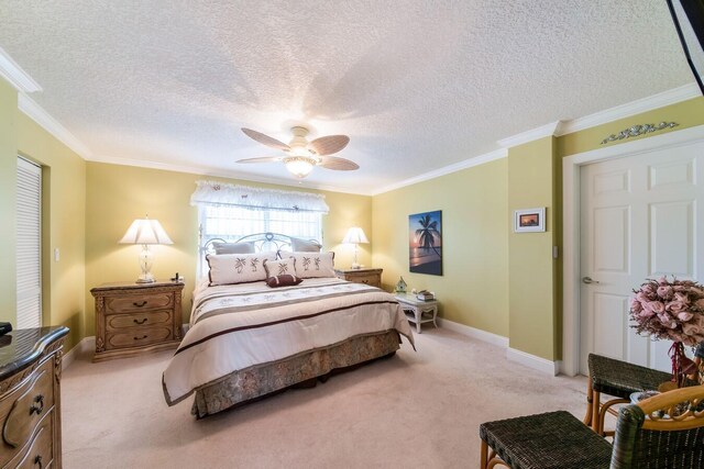 bedroom featuring ceiling fan, light colored carpet, a textured ceiling, and ornamental molding