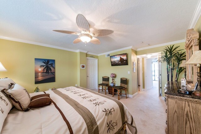 bedroom with ornamental molding, ceiling fan, light colored carpet, and a textured ceiling