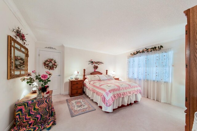 carpeted bedroom with ornamental molding