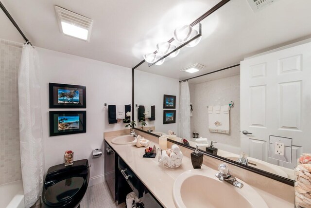 bathroom featuring vanity and shower / bath combination with curtain