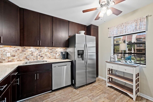 kitchen with sink, tasteful backsplash, light wood-type flooring, and stainless steel appliances