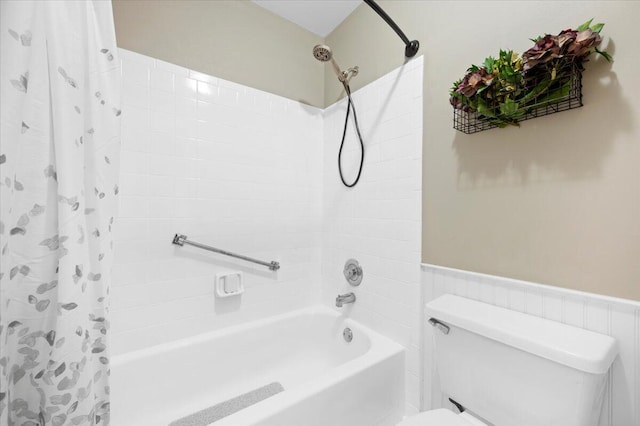 bathroom with shower / bath combo, toilet, and tile walls