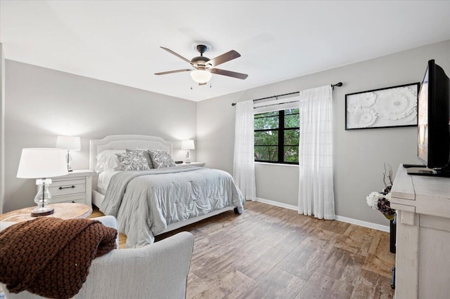 bedroom with ceiling fan and hardwood / wood-style floors