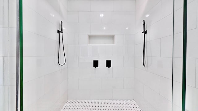 bathroom with tiled shower