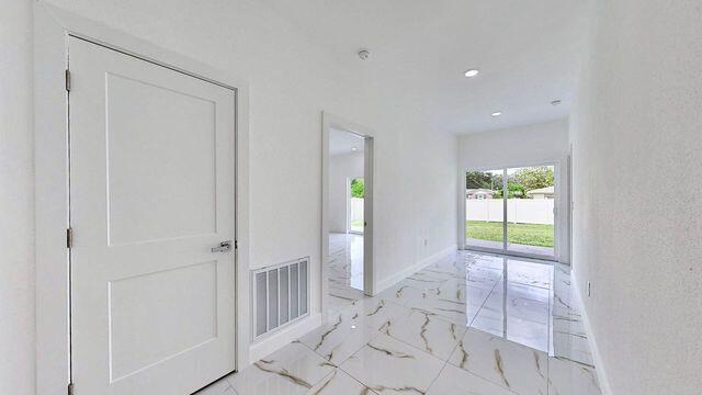 corridor with light tile patterned flooring