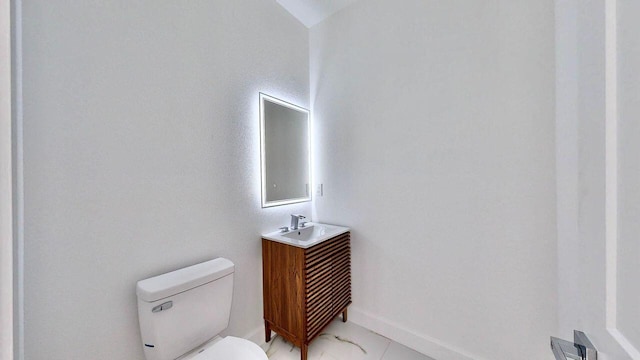 bathroom with vanity, tile patterned flooring, and toilet