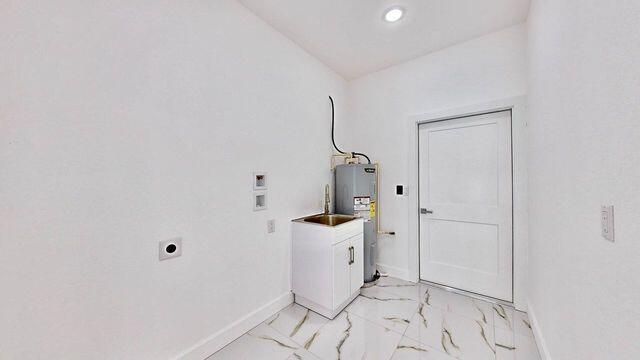 laundry area with light tile patterned flooring, hookup for an electric dryer, electric water heater, washer hookup, and cabinets