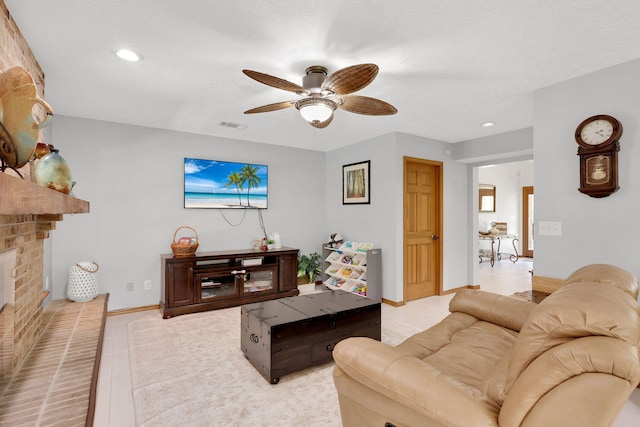 tiled living room with ceiling fan and a brick fireplace