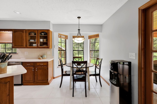 tiled dining area featuring a textured ceiling