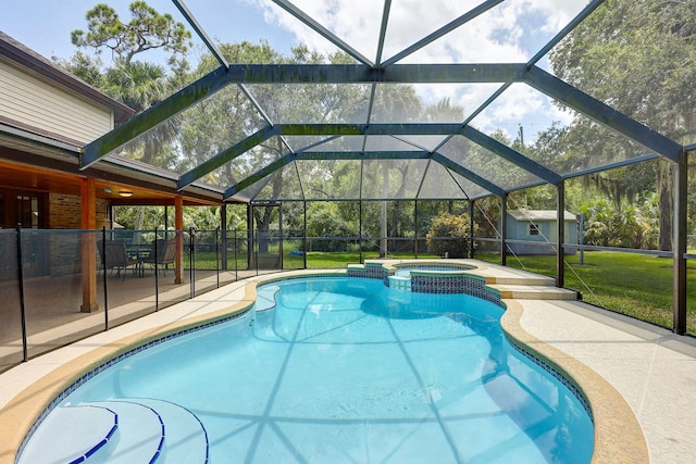 view of pool featuring a lawn, a shed, a patio, glass enclosure, and an in ground hot tub