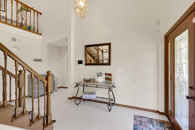 foyer featuring a high ceiling and light tile patterned floors