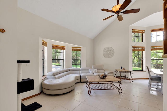 tiled living room featuring ceiling fan and high vaulted ceiling