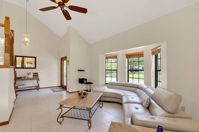 living room with ceiling fan with notable chandelier, light tile patterned floors, and high vaulted ceiling