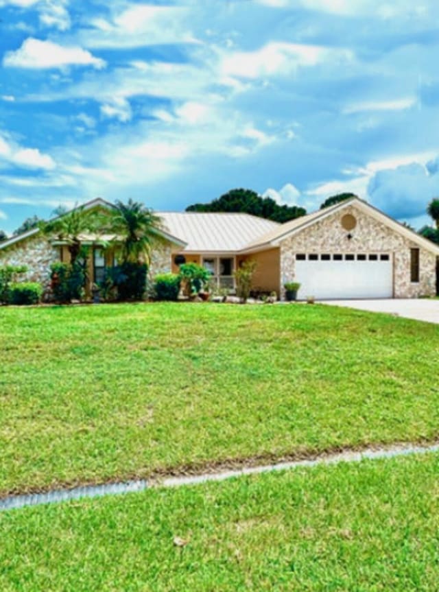 single story home featuring a front yard and a garage