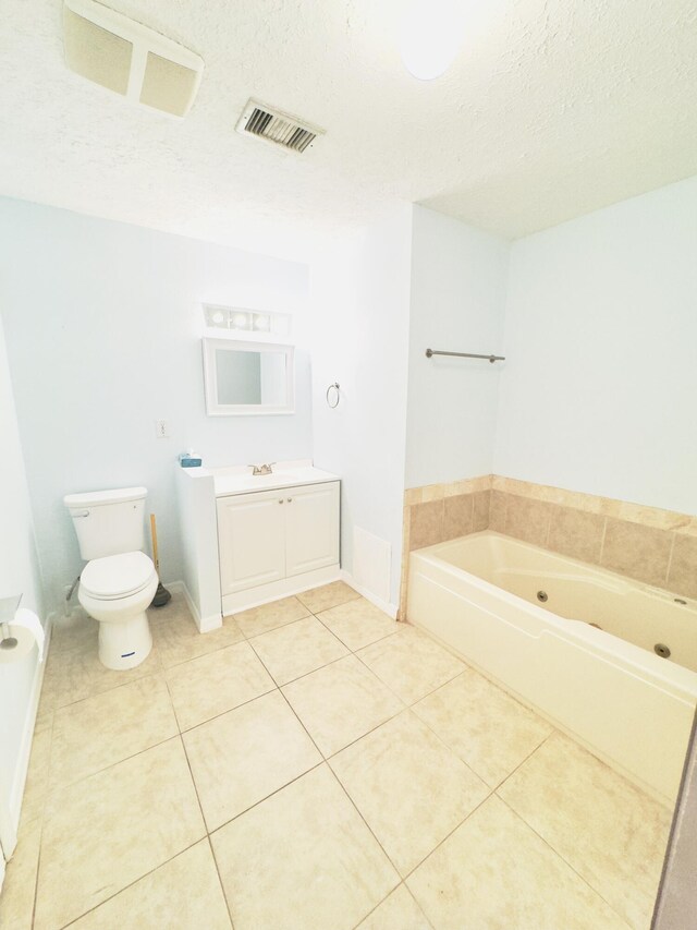 bathroom featuring a textured ceiling, tile patterned flooring, vanity, toilet, and a washtub