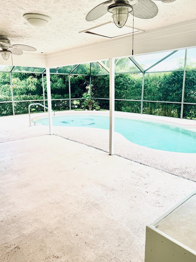 view of pool featuring ceiling fan, a patio area, and a lanai