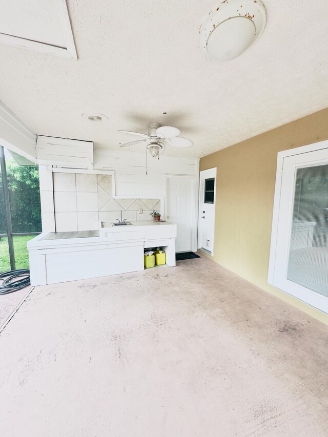 view of patio featuring ceiling fan