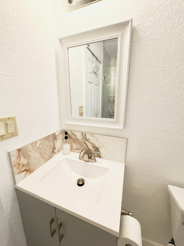 bathroom featuring toilet and vanity