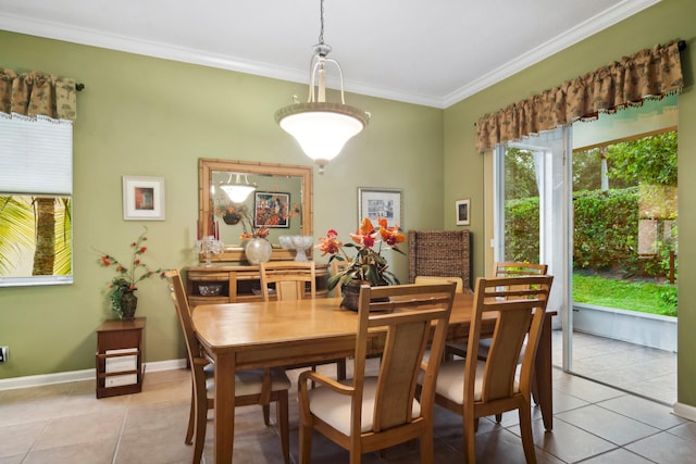 dining area featuring crown molding and light tile patterned floors