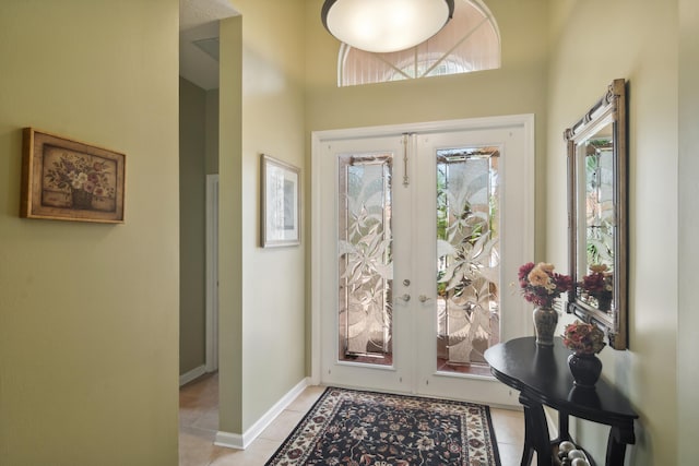 entryway featuring a wealth of natural light, light tile patterned floors, and french doors