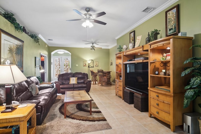 living room featuring light tile patterned flooring, ceiling fan, and ornamental molding