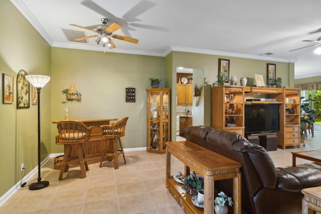 living room with ornamental molding, light tile patterned floors, bar area, and ceiling fan