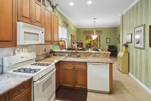 kitchen with sink, white appliances, light tile patterned floors, decorative light fixtures, and kitchen peninsula