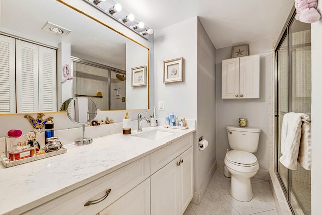 bathroom with vanity, tile patterned floors, walk in shower, and toilet