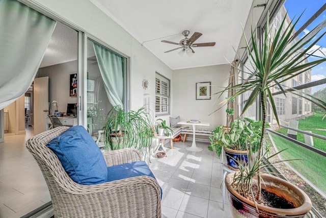 sunroom / solarium featuring ceiling fan