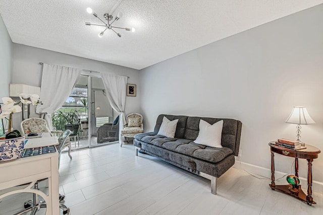 living room featuring a textured ceiling and a notable chandelier