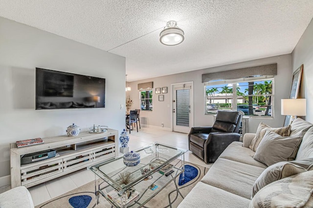 living room with a textured ceiling and light tile patterned floors