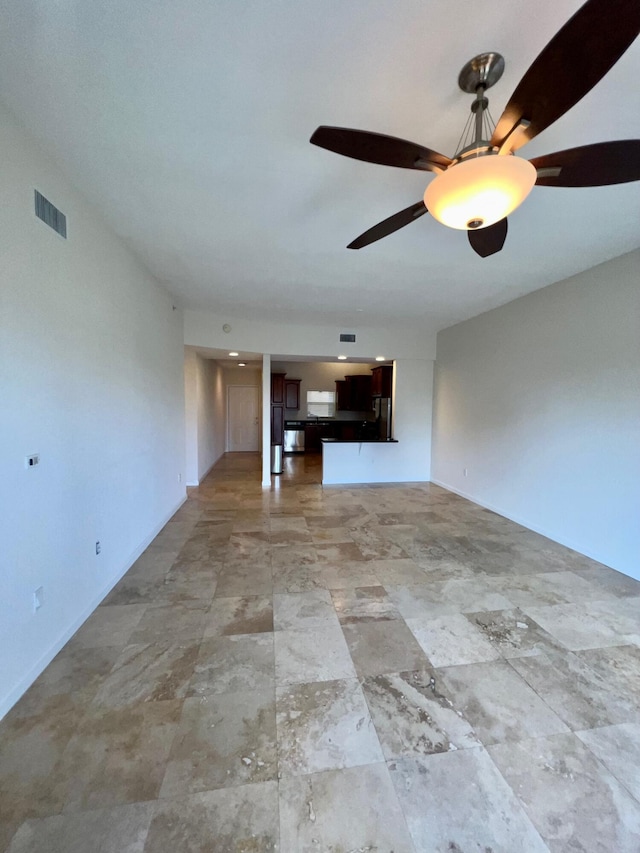 unfurnished living room featuring visible vents and a ceiling fan