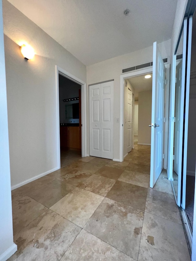 corridor with visible vents and baseboards