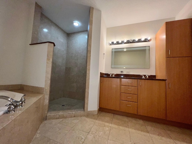 full bathroom featuring a stall shower, a bath, and double vanity