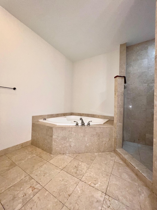 full bath with a tile shower and a bath