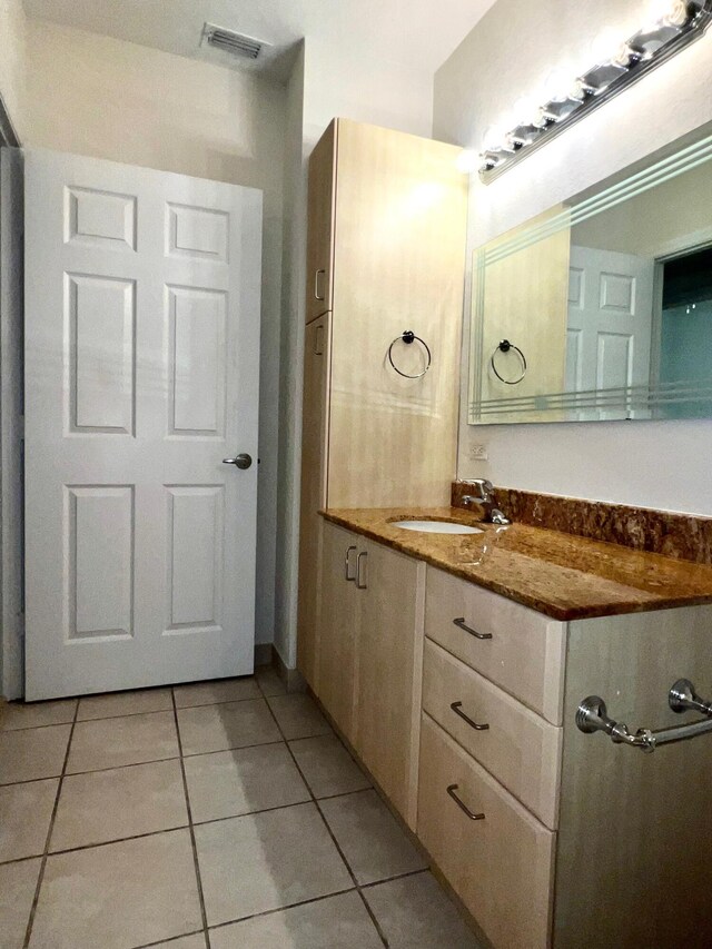 bathroom with tile patterned floors and vanity