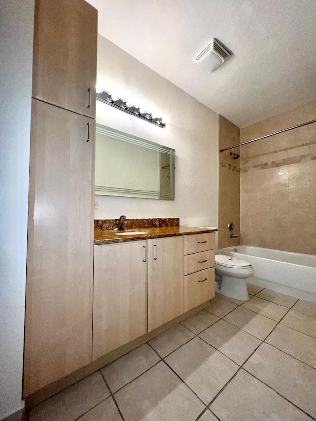 full bath with tile patterned flooring, toilet, vanity, visible vents, and shower / bathing tub combination