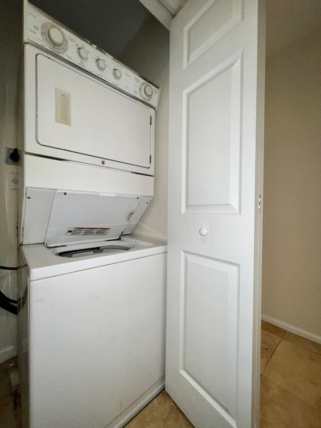 laundry room featuring stacked washing maching and dryer and laundry area