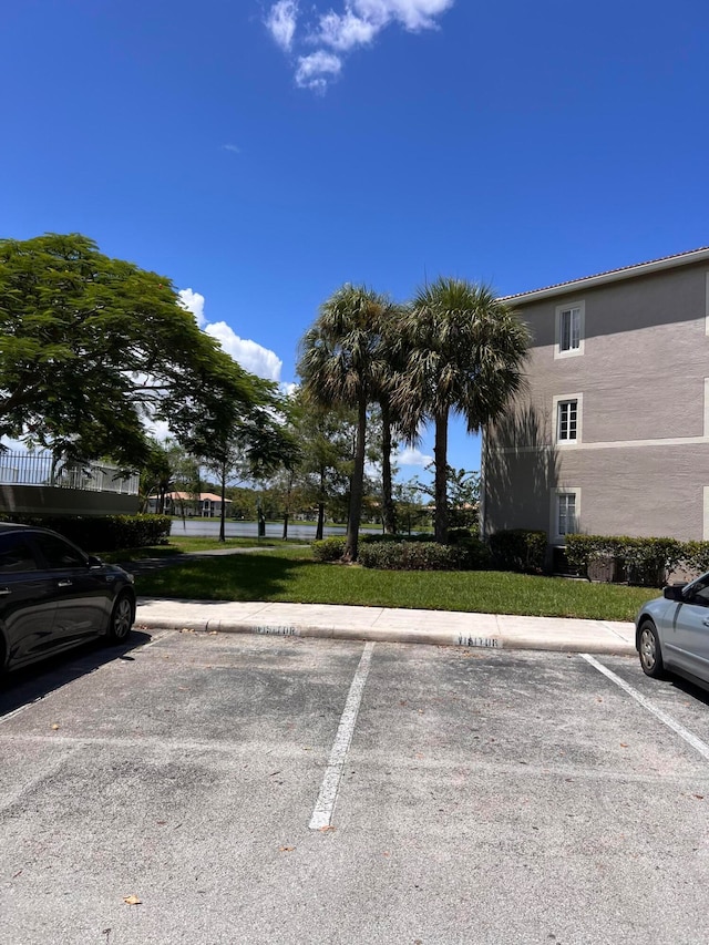 view of car parking with a yard