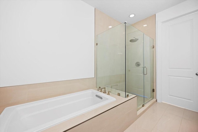 bathroom with separate shower and tub and tile patterned floors