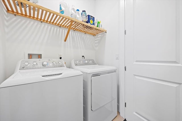 clothes washing area with washing machine and dryer